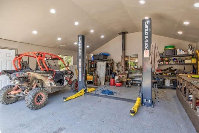 1499 Sawmill Road, Unit 594 Copperopolis, CA 95228 - Photo 6 of 98 Wood stove in garage and LED lighting. (Car lift no longer present and not included in the sale).