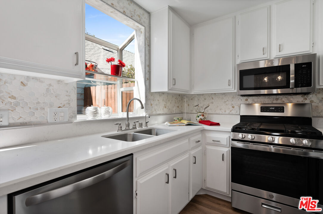 591 Garfield Avenue, Unit 5 Pasadena, CA 91101 - Photo 17 of 48 a kitchen with cabinets appliances and a sink