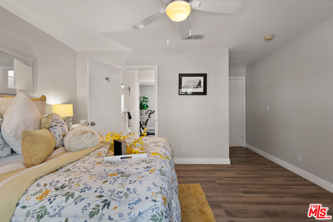 591 Garfield Avenue, Unit 5 Pasadena, CA 91101 - Photo 27 of 48 a bedroom with a bed and wooden floor