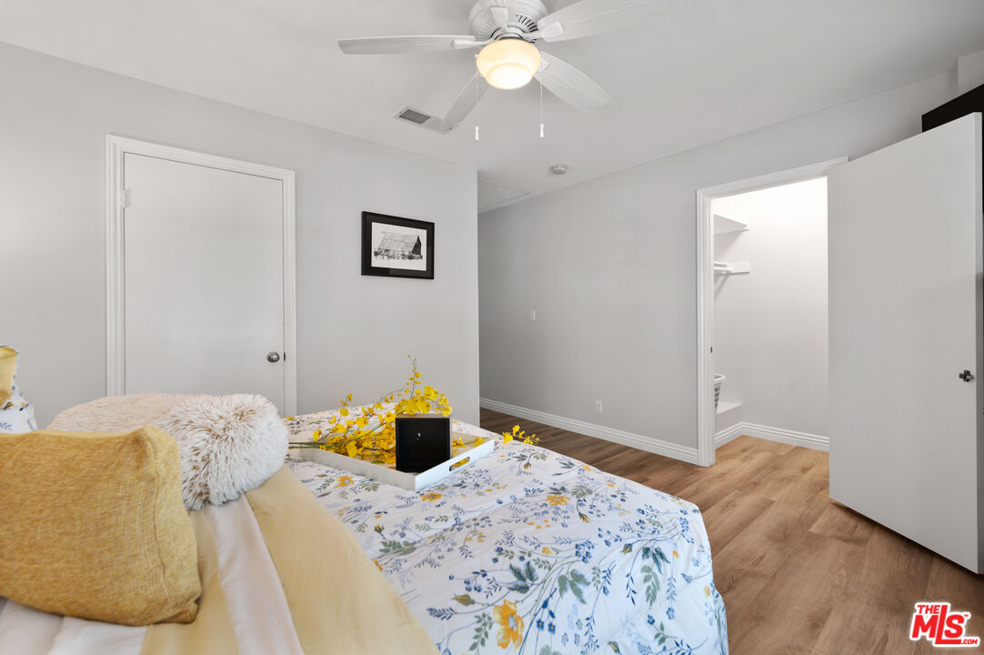 591 Garfield Avenue, Unit 5 Pasadena, CA 91101 - Photo 29 of 48 a bedroom with a bed and a chandelier