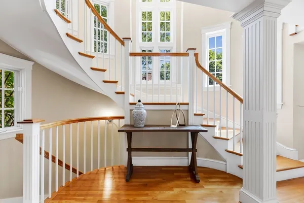 a view of entryway and hall with wooden floor