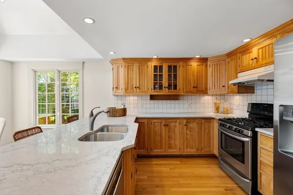 a kitchen with granite countertop a sink and a stove top oven