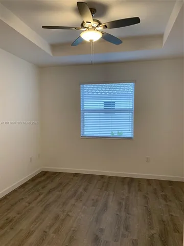 a view of room and chandelier fan