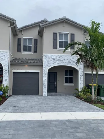 a front view of a house with yard