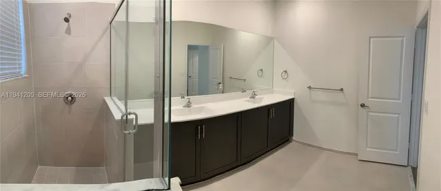 a bathroom with a double vanity sink and mirror