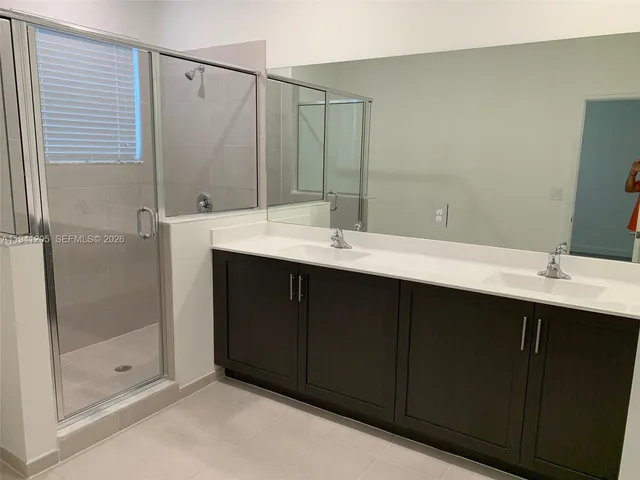 a bathroom with a double vanity sink mirror and double