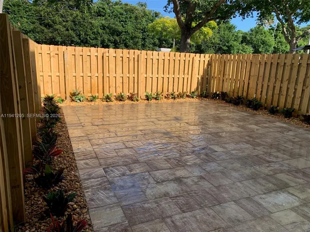 a view of a pathway with a wooden fence