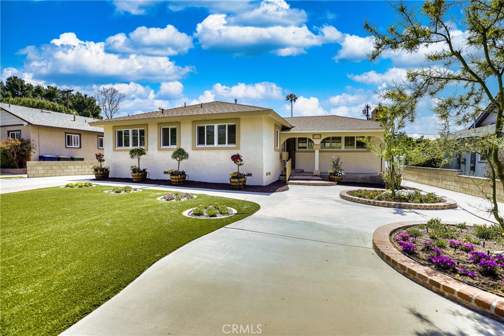 3542 Crowell Avenue Riverside, CA 92504 - Photo 1 of 1 a front view of a house with a garden and plants