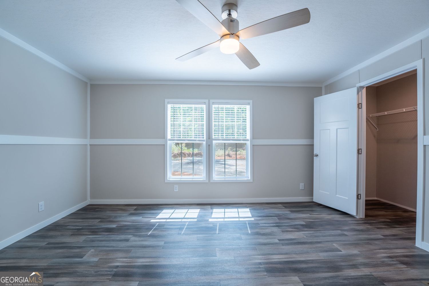 734 Hollywood Church Road Clarkesville, GA 30523 - Photo 29 of 49 an empty room with wooden floor and windows