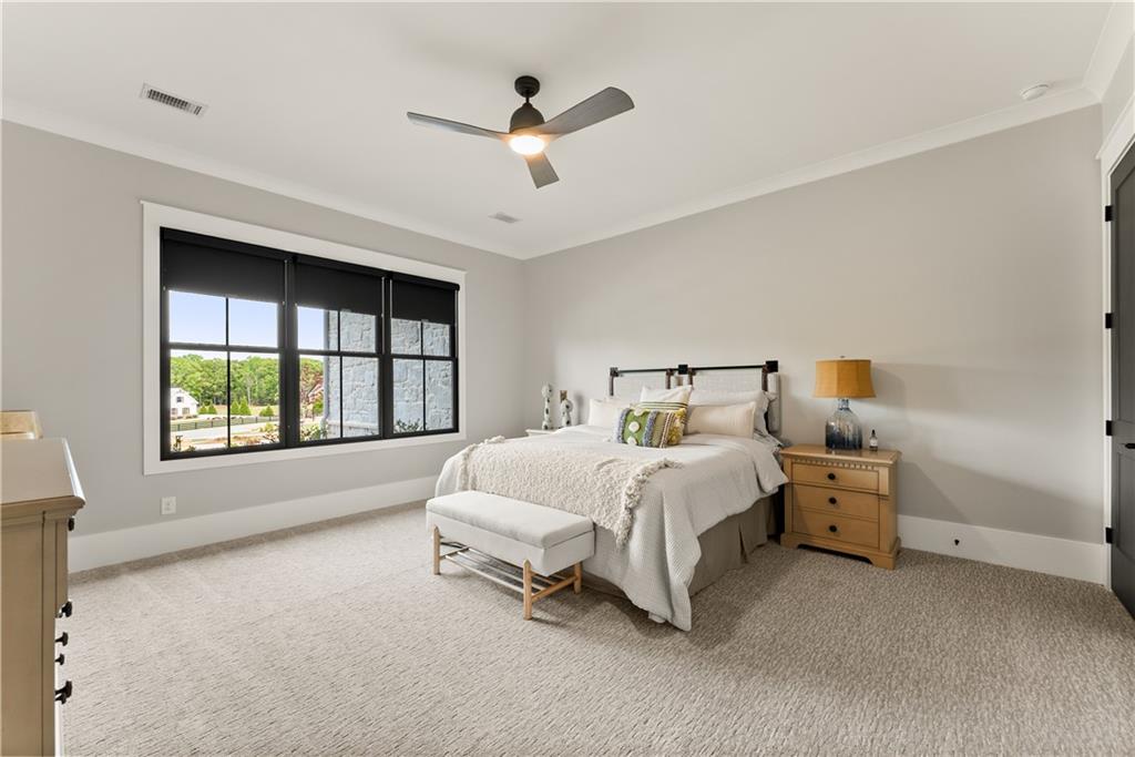 373 Fortress Way Jefferson, GA 30549 - Photo 15 of 118 a spacious bedroom with a bed and a large window