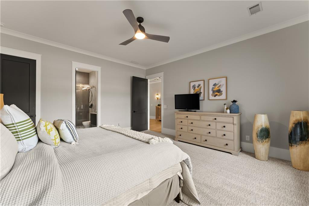373 Fortress Way Jefferson, GA 30549 - Photo 16 of 118 a bedroom with a bed a dresser and a mirror