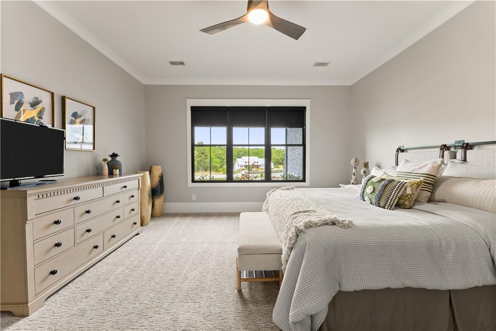 373 Fortress Way Jefferson, GA 30549 - Photo 17 of 118 a bedroom with a large bed and a flat tv screen on dresser