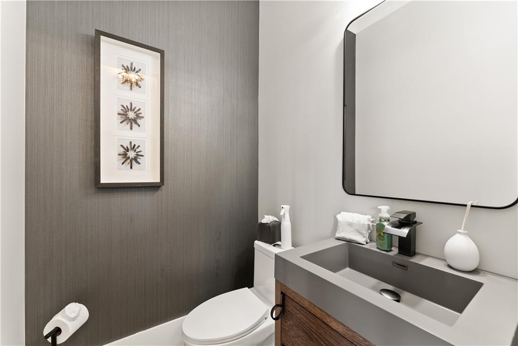 373 Fortress Way Jefferson, GA 30549 - Photo 19 of 118 a white toilet sitting next to a bathroom sink