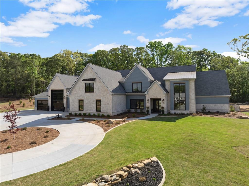 373 Fortress Way Jefferson, GA 30549 - Photo 4 of 118 a view of a house with a big yard and large tree