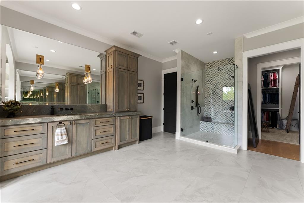 373 Fortress Way Jefferson, GA 30549 - Photo 58 of 118 a large bathroom with a large mirror vanity and shower