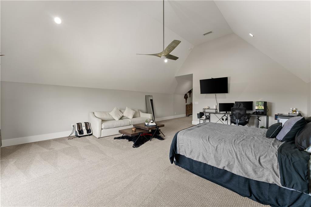 373 Fortress Way Jefferson, GA 30549 - Photo 67 of 118 a bedroom with bed and a chandelier