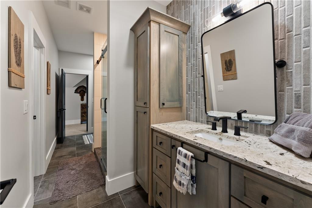 373 Fortress Way Jefferson, GA 30549 - Photo 70 of 118 a bathroom with double vanity sinks and a mirror