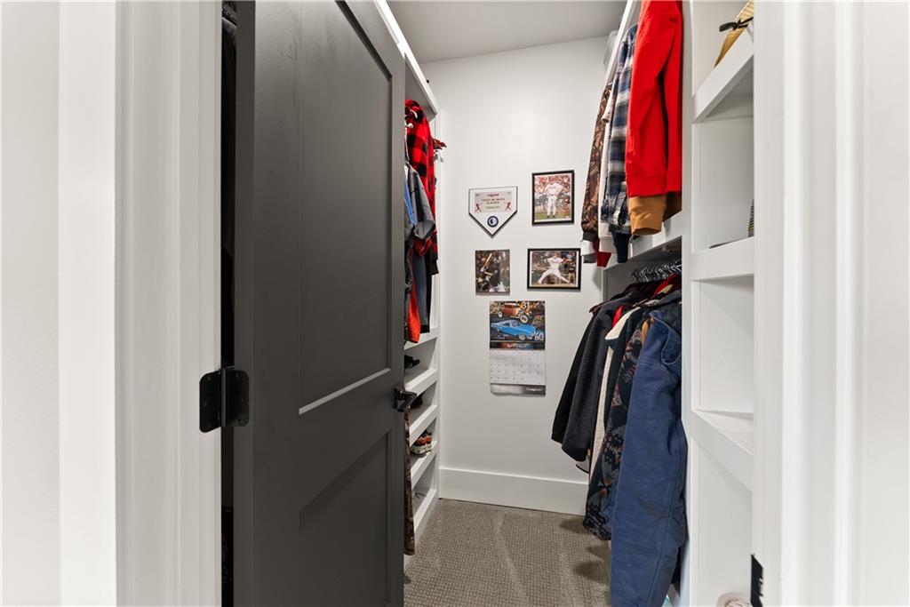 373 Fortress Way Jefferson, GA 30549 - Photo 73 of 118 a view of walk in closet with clothes and shoes