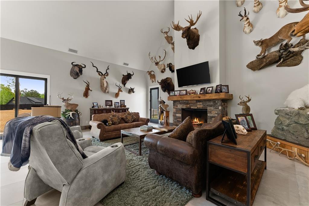 373 Fortress Way Jefferson, GA 30549 - Photo 75 of 118 a living room with furniture a flat screen tv and a fireplace