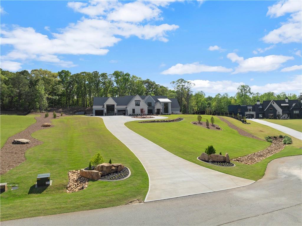 373 Fortress Way Jefferson, GA 30549 - Photo 10 of 118 a view of a swimming pool with a garden and trees