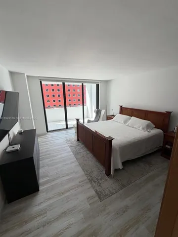 a bedroom with a bed and a television