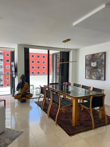 a living room with furniture a rug and a large window