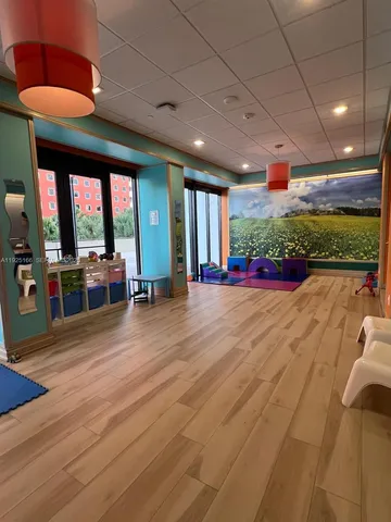 a room with gym equipment and glass window