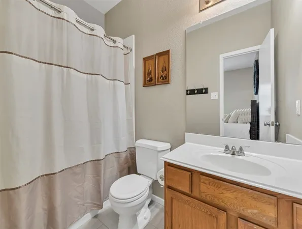 a view of a room with cabinet and a ceiling fan