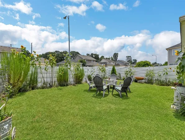 a view of a backyard with wooden fence