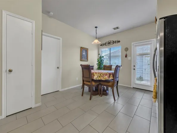 a view of a dining room with furniture and window