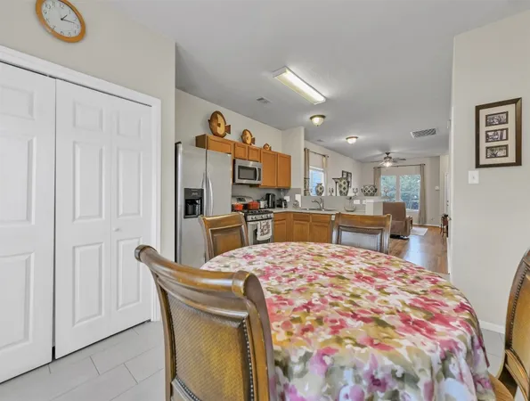 a dining table chair and a refrigerator in a kitchen