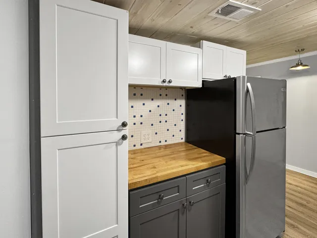 a kitchen with refrigerator and cabinet