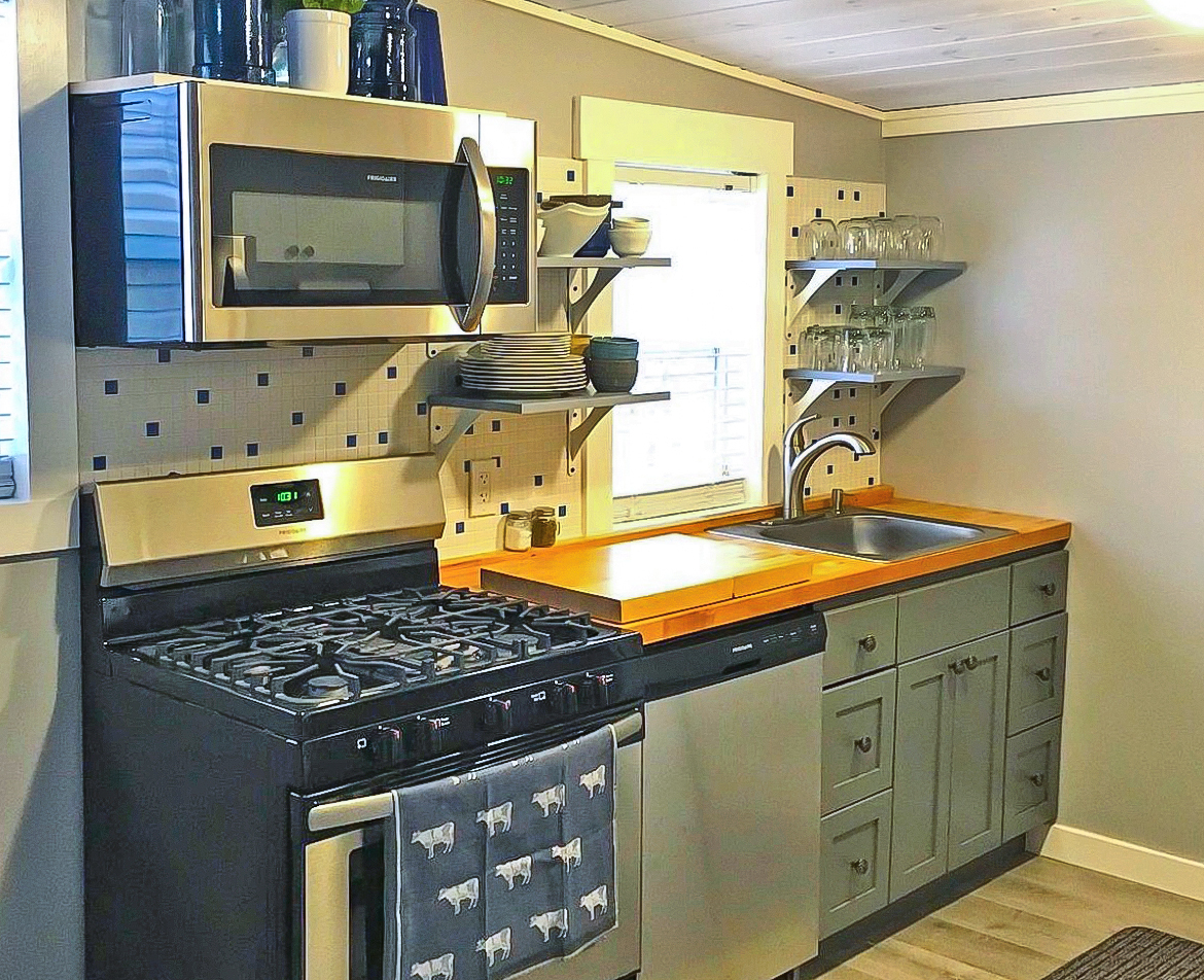200 East Grove Street Utica, IL 61373 - Photo 18 of 41 a kitchen with stainless steel appliances granite countertop a stove and a microwave