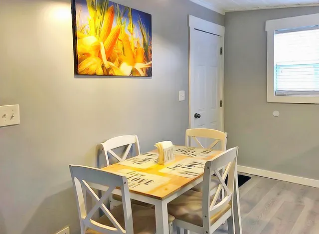 a view of a dining room with a table and chairs