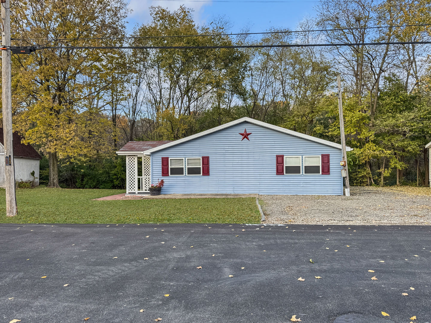 200 East Grove Street Utica, IL 61373 - Photo 24 of 41 a view of a yard in front of a house with large trees