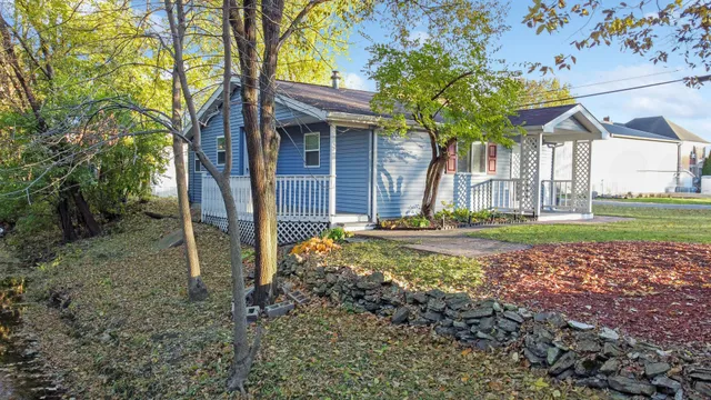 a view of a house with backyard and a tree