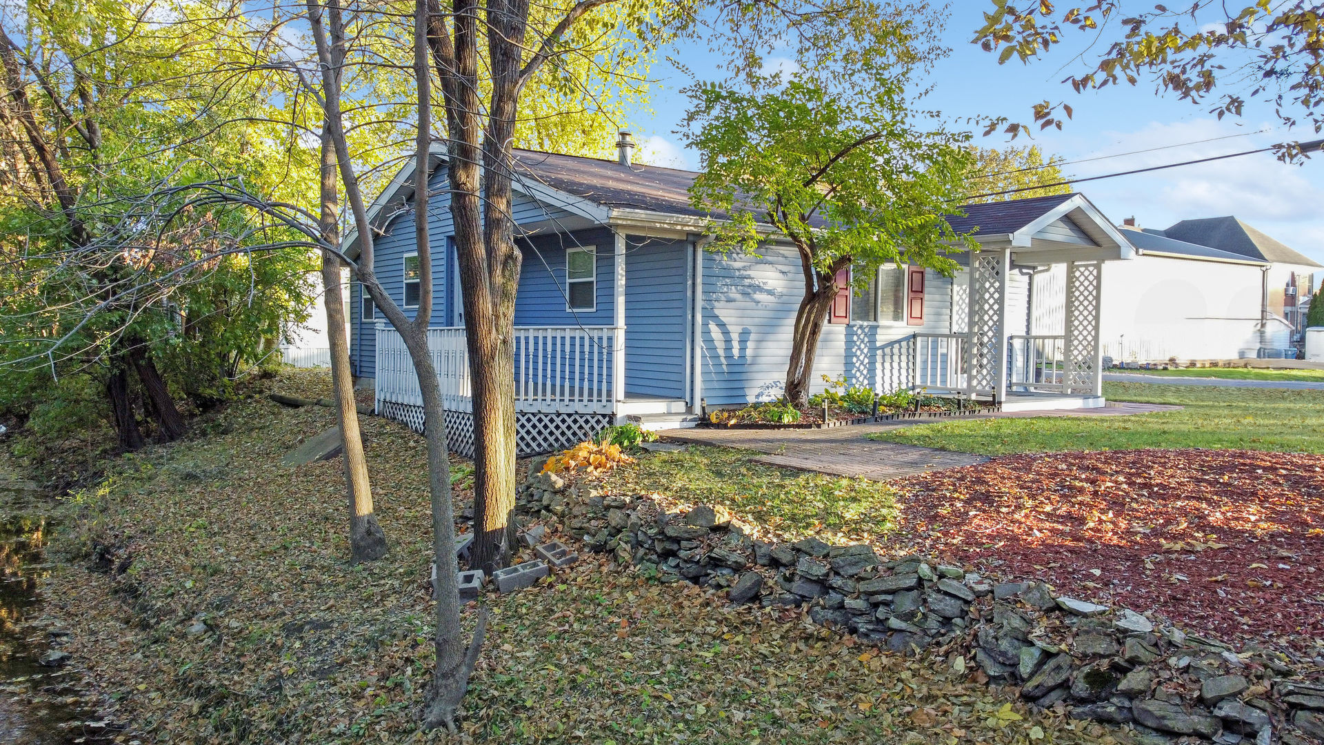 200 East Grove Street Utica, IL 61373 - Photo 30 of 41 a view of a house with backyard and a tree