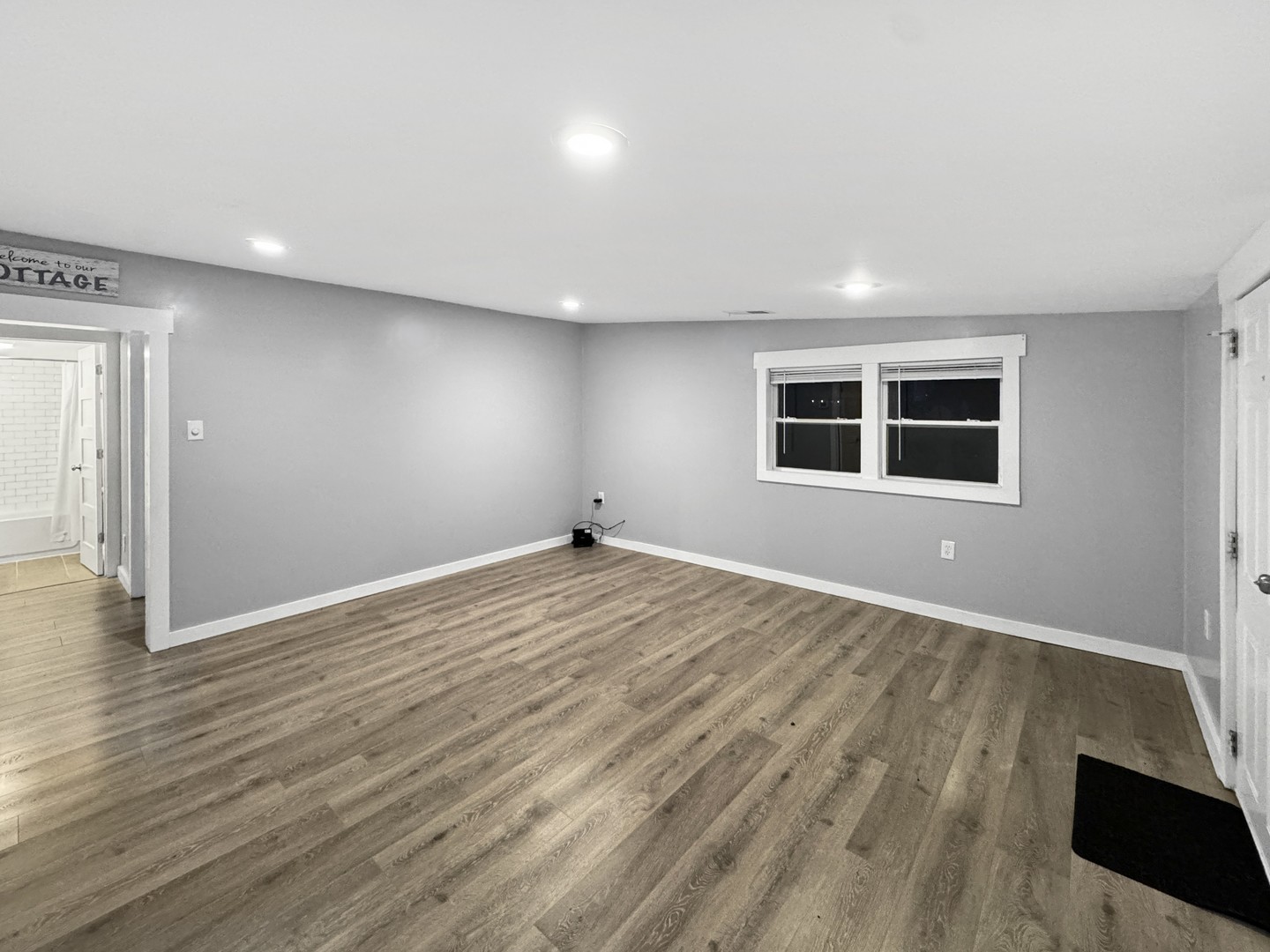 200 East Grove Street Utica, IL 61373 - Photo 4 of 41 an empty room with wooden floor and windows