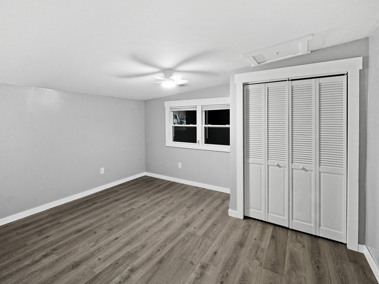 200 East Grove Street Utica, IL 61373 - Photo 6 of 41 a view of an empty room with wooden floor and a window
