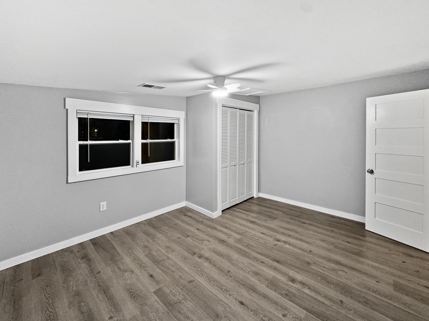 200 East Grove Street Utica, IL 61373 - Photo 7 of 41 a view of an empty room with wooden floor and a window