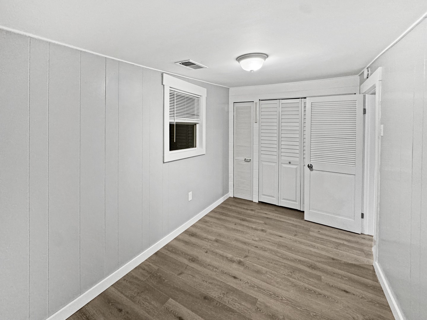 200 East Grove Street Utica, IL 61373 - Photo 9 of 41 an empty room with wooden floor and windows