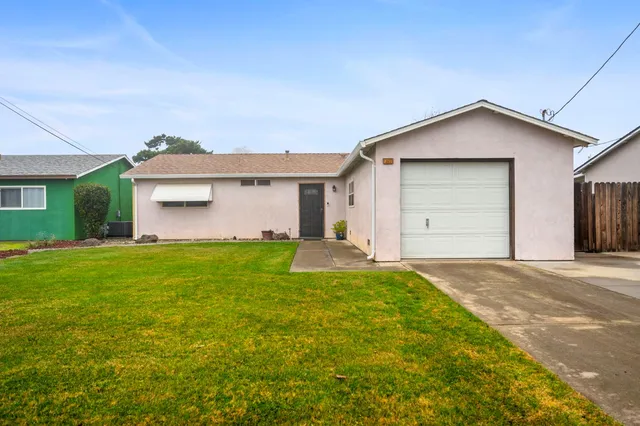 a view of a house with a yard and garage