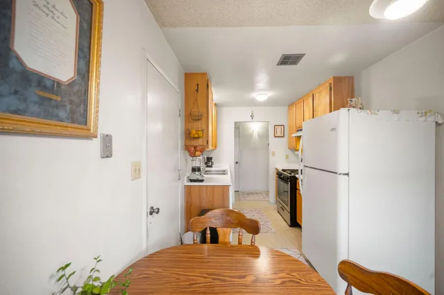 a bedroom with a bed and a refrigerator