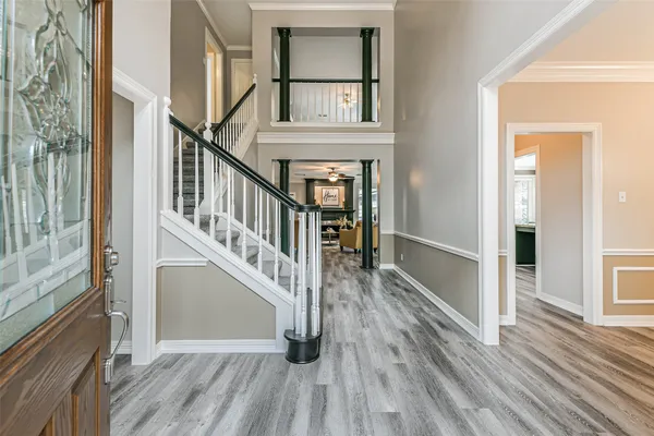 a view of entryway with wooden floor and stairs