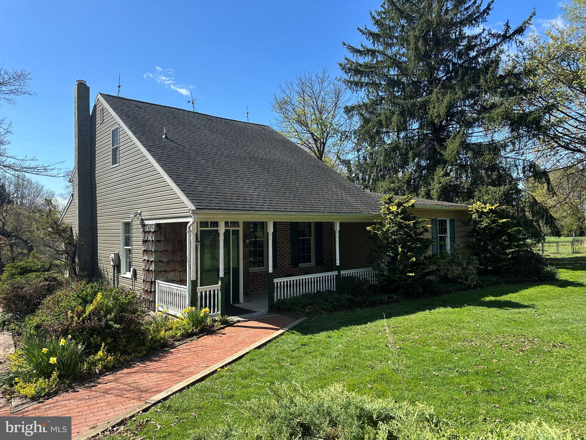 a view of a house with garden and yard