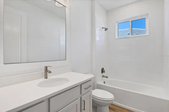 a bathroom with a sink toilet and a mirror