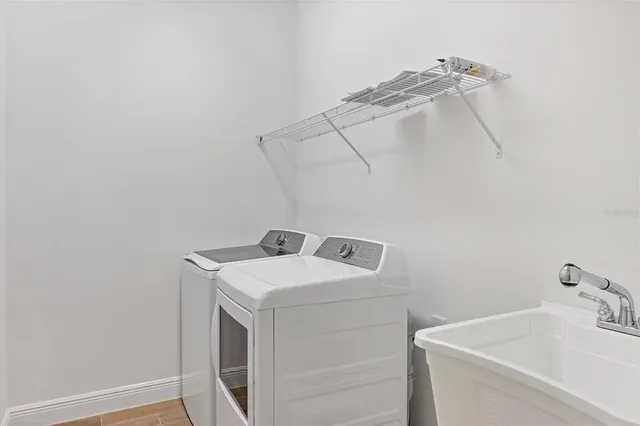 a utility room with a sink washer and dryer