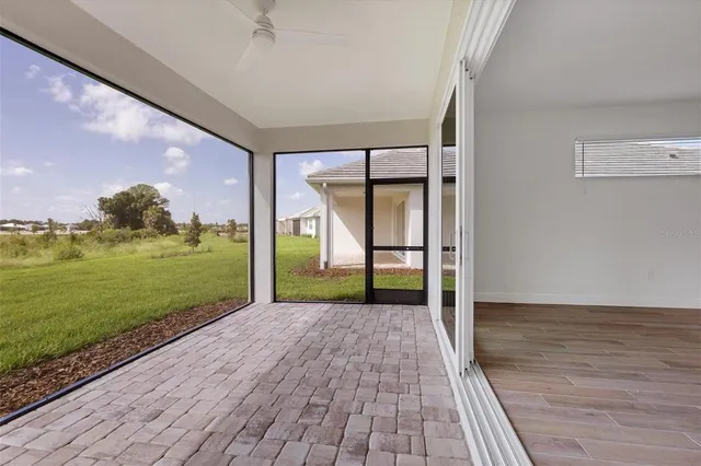 a view of a room with wooden floor and door