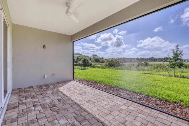 a view of a big yard with swimming pool and green space