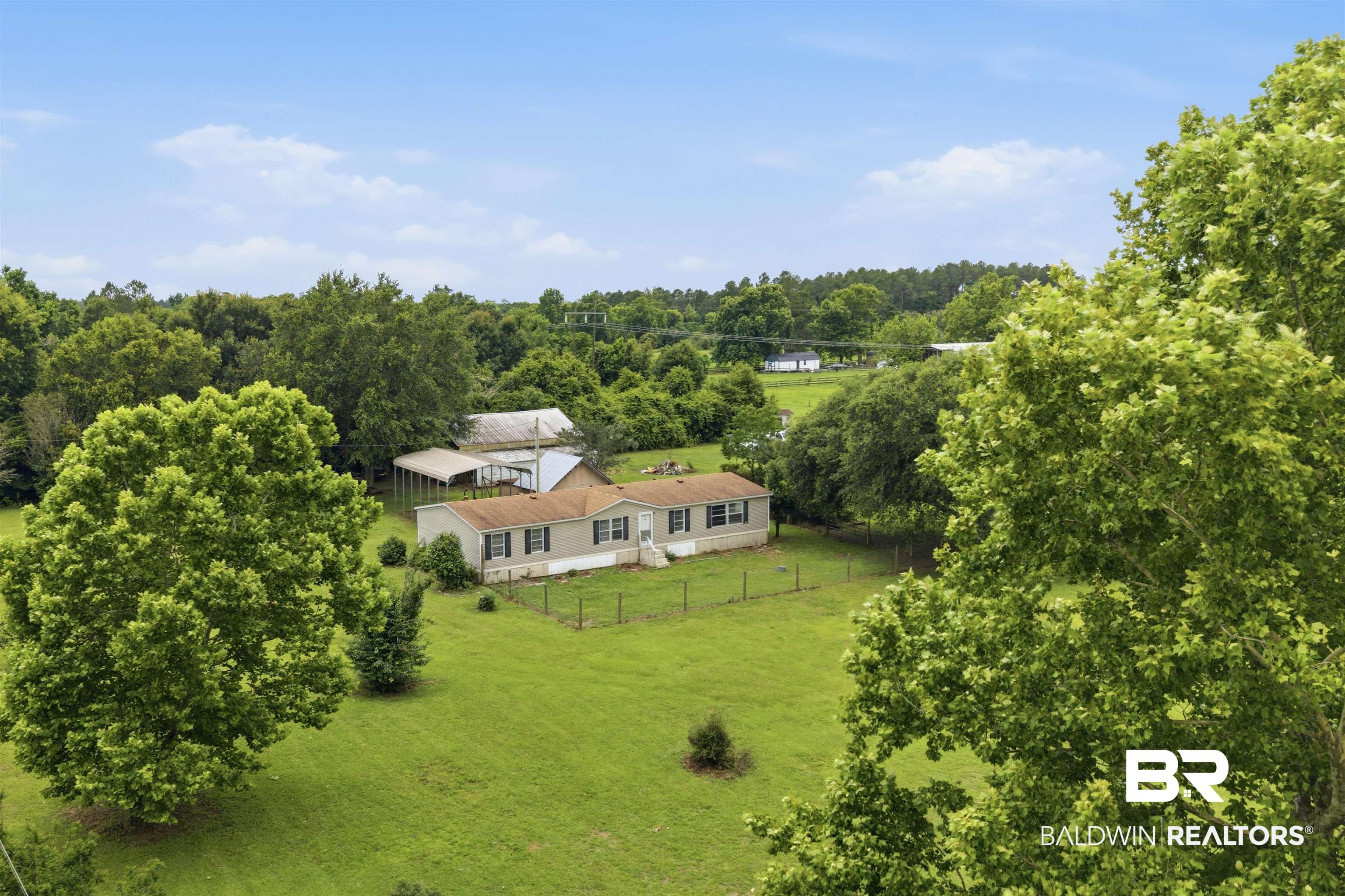 26788 Feely Road Elberta, AL 36530 - Photo 20 of 31 Expansive green landscape featuring a single-story residence, mature trees, and a distant barn structure